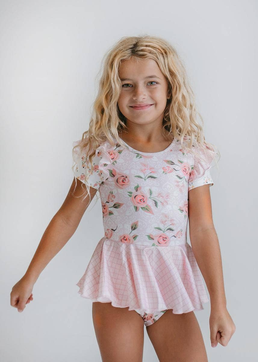Maillot de gimnasia con falda y volantes para niños en color rosa pálido